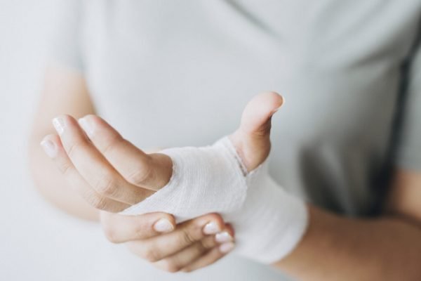 Woman with gauze bandage wrapped around her hand